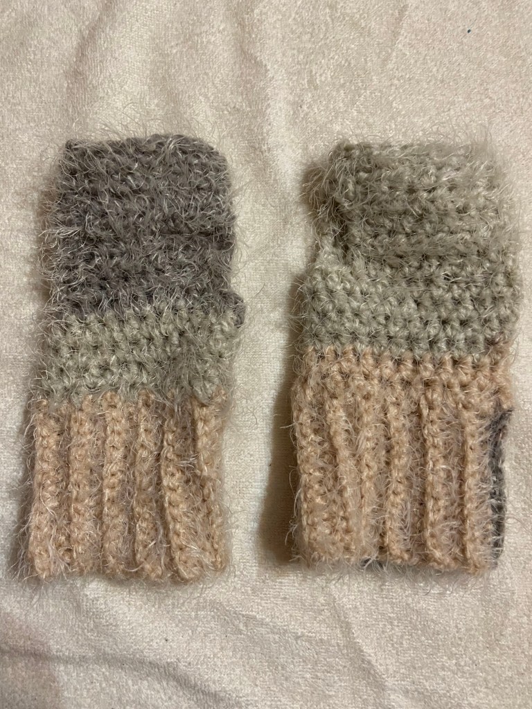 Grey, white, and pink fingerless gloves on a white background.